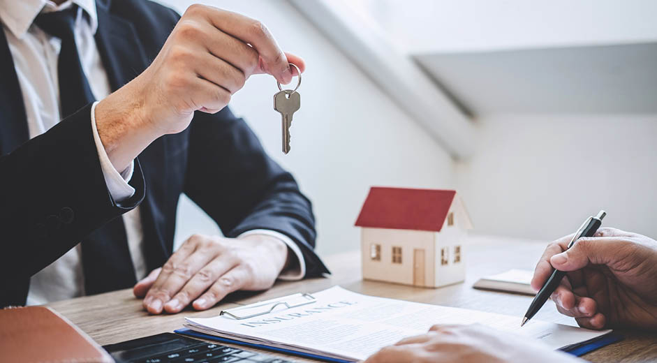 Estate agent giving house keys to client after signing agreement contract real estate with approved mortgage application form, concerning mortgage loan offer for and house insurance 