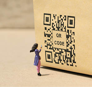 QR Code conceptual design on the brown table. Background is blurred.